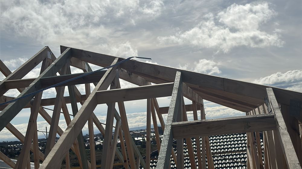 Strap brace not bent over the end truss top chord and nailed off, found during a frame stage inspection in Manor Lakes