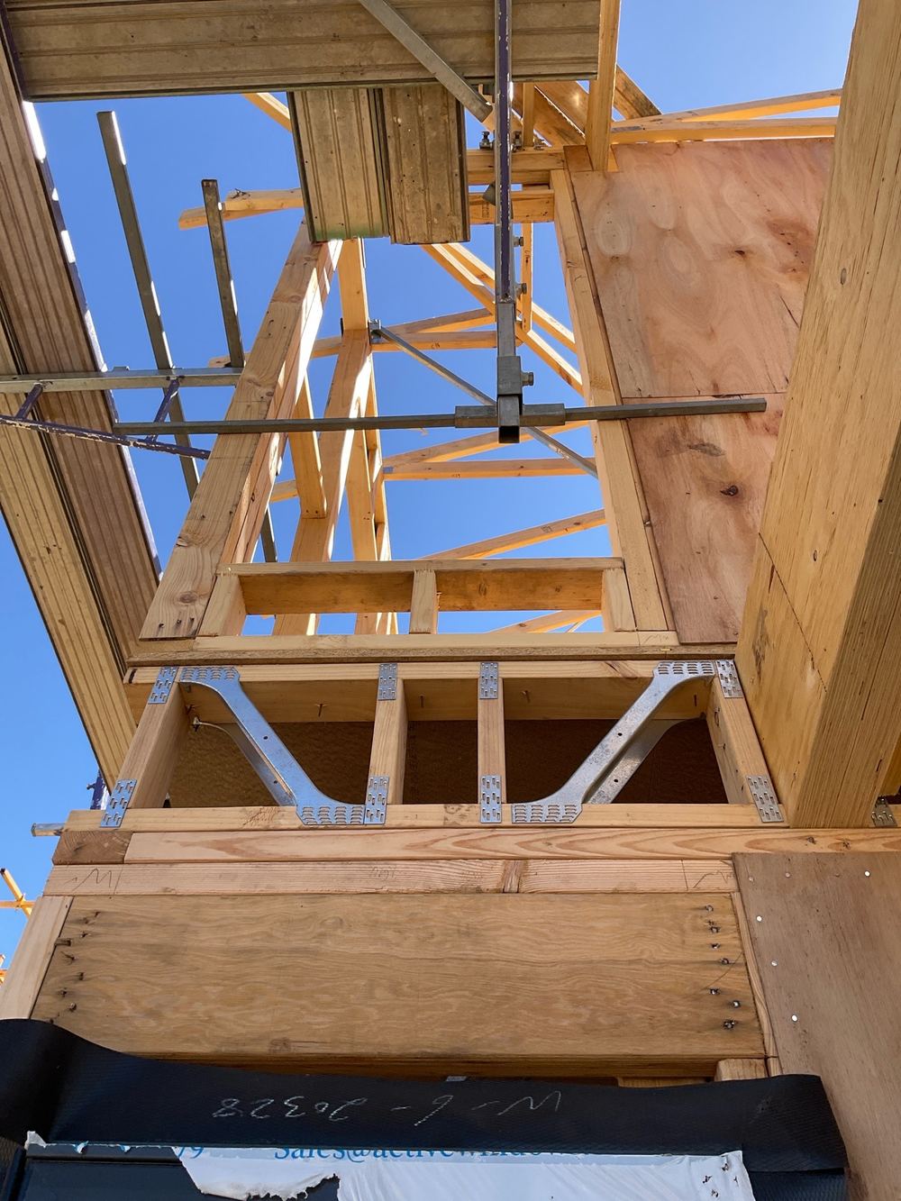 Tie-down straps and blocks left incomplete on a wall frame, found during a frame stage inspection in Manor Lakes