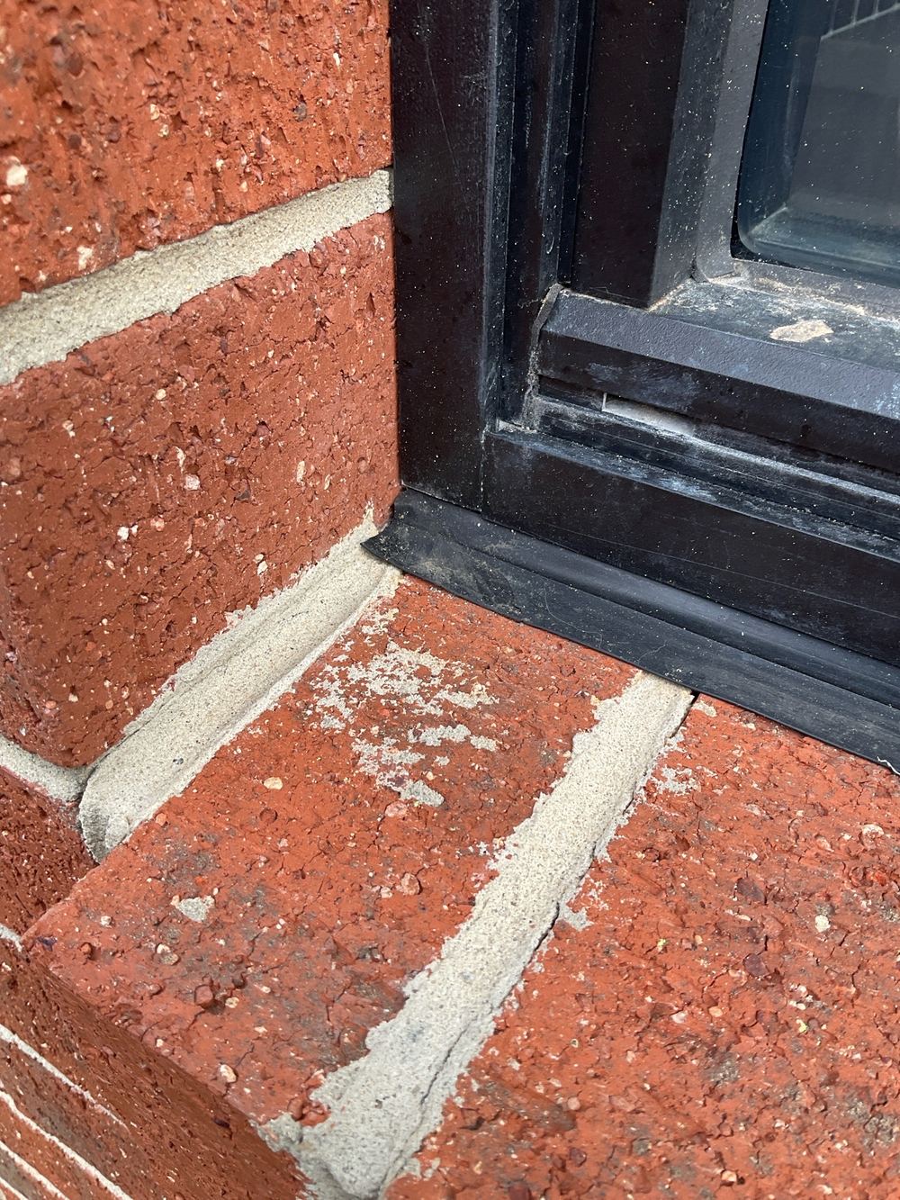 Mortar droppings and smears left across the face brickwork, Manor Lakes