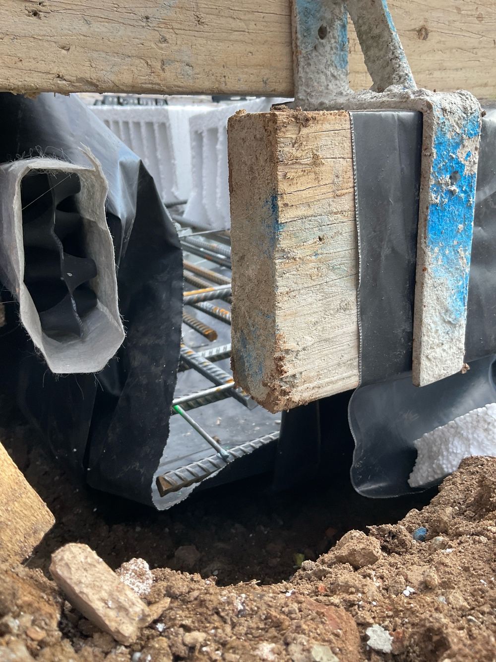 Vapour barrier draped over the reinforcement instead of lying beneath it, found during a slab pre-pour inspection in Manor Lakes